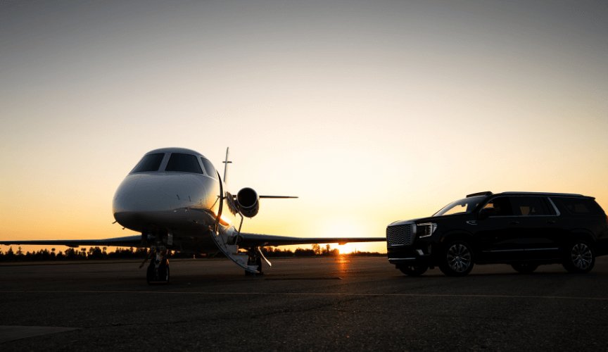 Image of small private jet at airport with black car suv for pick up and drop off next to it representing hwd airport car service