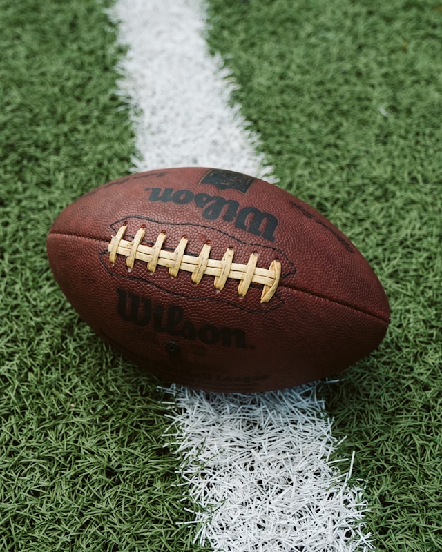 Image of football on grass representing superbowl 60